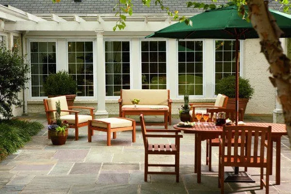 Grouped casement windows beside an outdoor patio