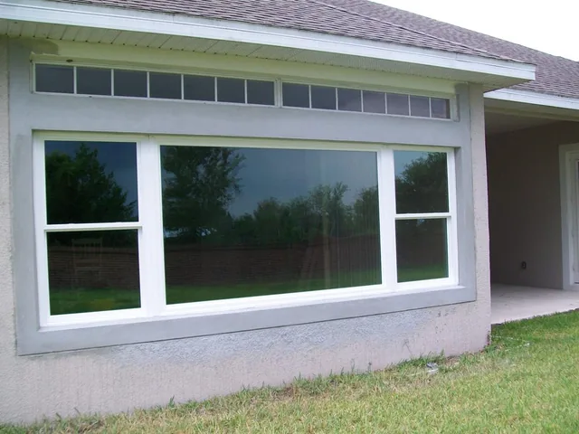 Large white-framed picture window with smaller windows on either side.