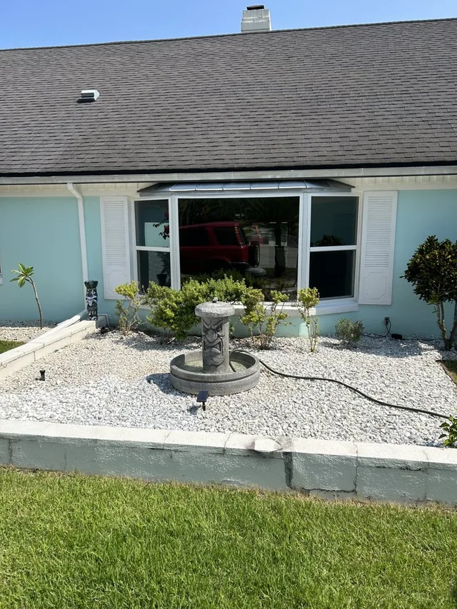 White-framed window combination overlooking a front garden.