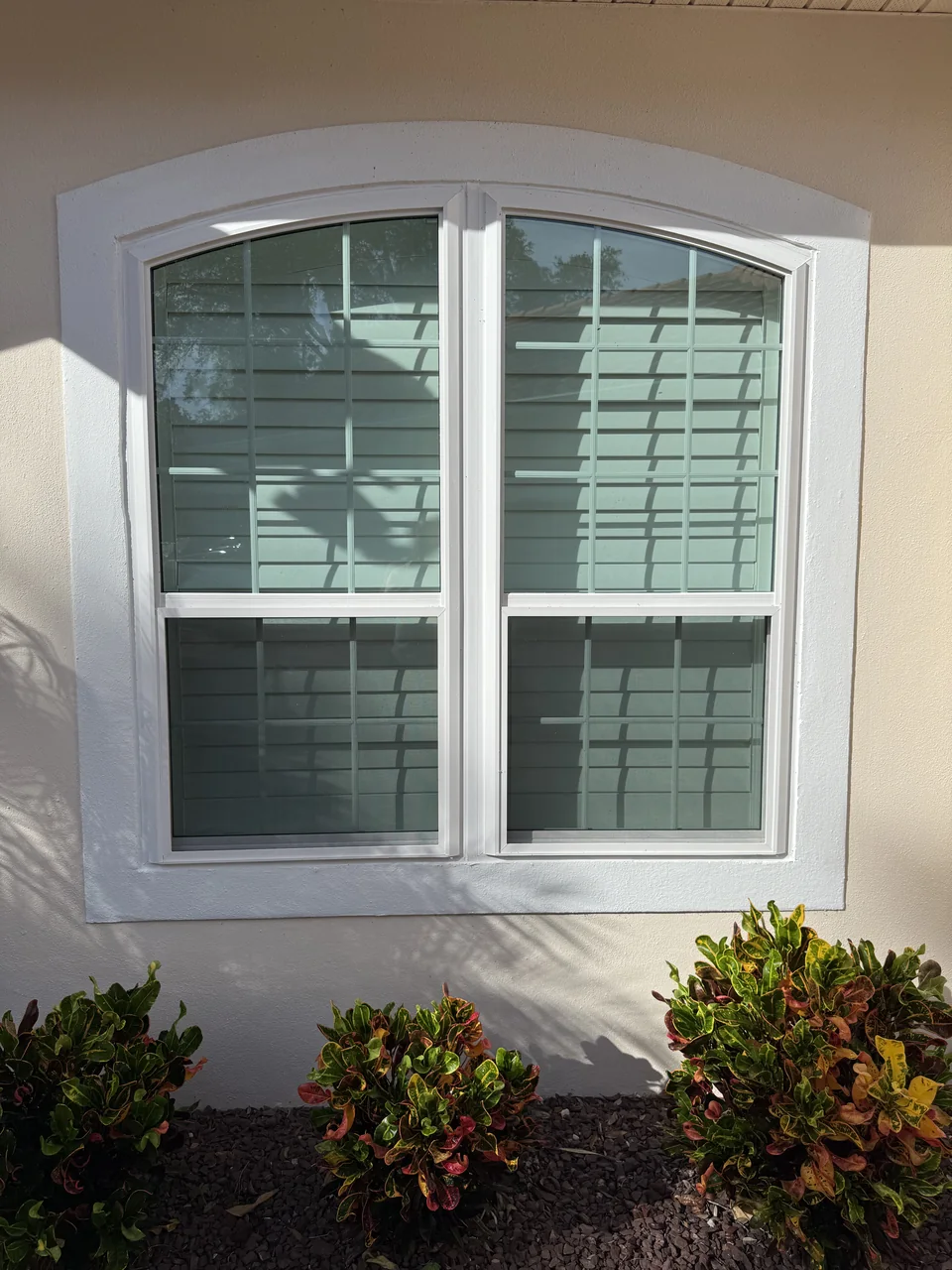 The same arched opening after Colonial installed white grid windows